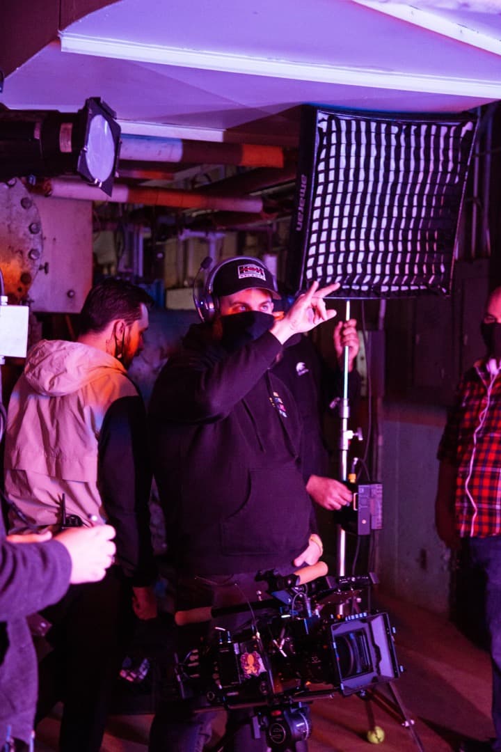 Behind the scenes photo 25 from Clone Cops production showing cinematographer corey allen preparing for a scene in the boiler room